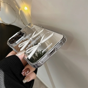 Detail of clear TPU iPhone case featuring elegant silver and white 3D bowknot ornaments