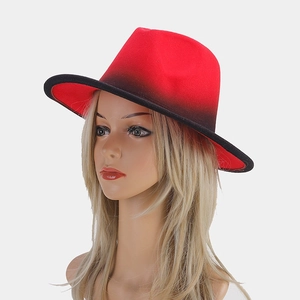 Macro side view of red and black gradient wide-brimmed fedora hat on model