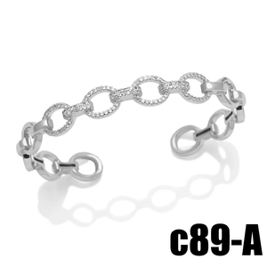 Modern open cuff bracelet featuring alternating polished silver links and pavé zircon stones