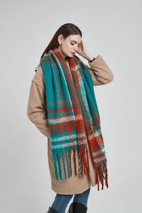 Winter chunky plaid scarf with tassels in blue and rust red on model with fleece coat