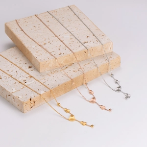 Three elegant stainless steel gourd pendant necklaces in gold, rose gold, and silver finishes