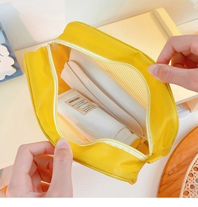 Detail of yellow mesh cosmetic bag showing zipper opening and spacious storage capacity