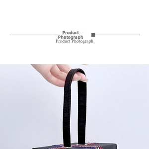 Detailed shot of black rhinestone handbag featuring colorful striped crystal embellishments