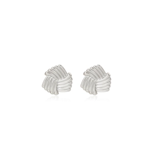 Detailed view of silver love knot stud earrings with polished metallic texture
