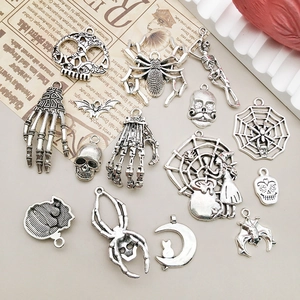 Macro view of assorted silver Halloween skull and spider alloy pendant charms