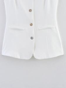 Detail of white waistcoat featuring three shell luster buttons and dual straight pockets