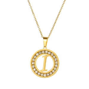 Detail of gold-tone round necklace pendant with hollow letter I and pave crystals