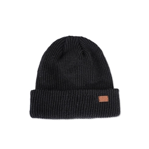 Close-up of black knit beanie featuring a brown leather patch and ribbed texture