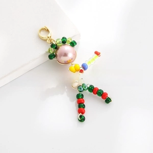 Detail of handmade colorful bead cartoon doll pendant with gold lobster clasp