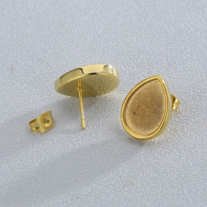 Macro shot of gold teardrop earring studs and butterfly backs for jewelry making