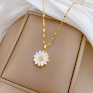 Rotating sunflower necklace with crystals on brown jewelry box with white soft fabric