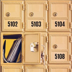 Vintage gold mailbox set with numbering stickers and open unit showing mail and keys