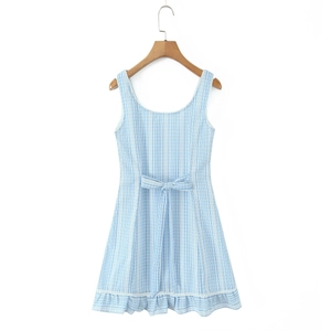 Detail of blue striped summer dress featuring a waist tie bow and ruffled lace hemline