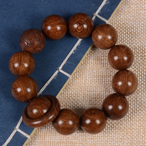 Authentic aged sandalwood prayer beads with natural wood grain and carved lucky charm bead