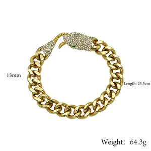 Gold Cuban chain bracelet with crystal snake head clasp and green eyes detail