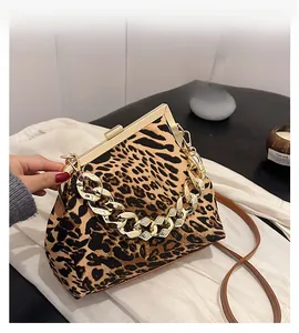 Detail view of leopard print handbag with vintage gold frame closure and chunky chain