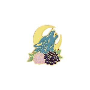 Detail of wolf and moon enamel brooch with gold plating and floral accents