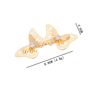 Golden butterfly hair clip with hollow metal design and sparkling zircon stones