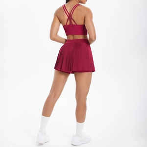Vue arrière d'un ensemble de yoga bordeaux avec soutien-gorge croisé et jupe plissée