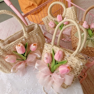 Straw handbags in pink shopping cart featuring tulips, pearls and organza ribbons