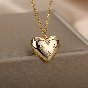 Macro shot of a golden heart-shaped necklace pendant with tiny inlaid rhinestones