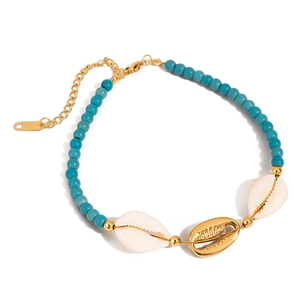 Macro view of bohemian turquoise bead anklet with gold and natural seashells