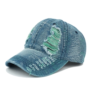 Distressed vintage navy denim baseball cap with frayed holes and green lining
