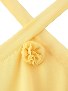 Close-up of yellow chiffon dress featuring handmade 3D floral details on the halter neck