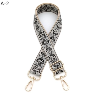 Detail of adjustable baroque jacquard guitar strap with polished gold hardware buckles