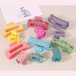 Flat lay of 11 matte shark hair claw clips in various pastel colors and sizes