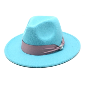 Detail of turquoise wool felt fedora hat featuring purple ribbon and rhinestone buckle
