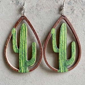 Macro view of teardrop wooden earrings featuring a detailed green cactus inner design