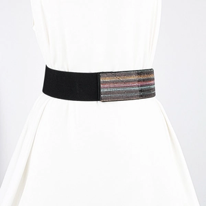 Close-up of black elastic waist belt with colorful stripe detail on white dress