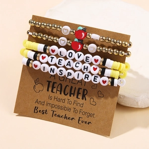 Detail of colorful polymer clay teacher bracelet set with LOVE and TEACH letter beads