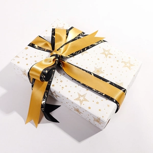 Luxury white gift box with gold star wrapping paper and black-gold satin ribbon bow