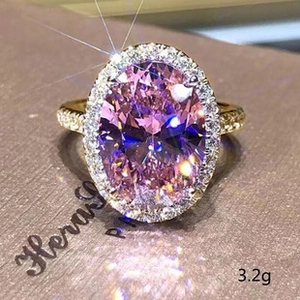 Macro shot of a 3.2g gold ring with an oval pink gemstone and sparkling pavé diamonds