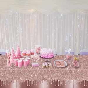 Rose gold glitter tablecloth for party setting with matching cake and tableware