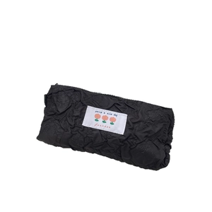 Minimalist black pleated pencil case with flower label and zip closure on white background
