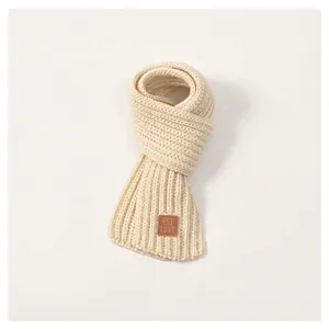 Soft cream knit scarf for kids with ribbed texture and brown leather EST LOVE patch