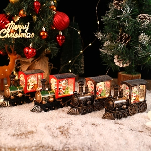 Christmas train lantern ornaments with Santa and snowman scenes in glowing festive light