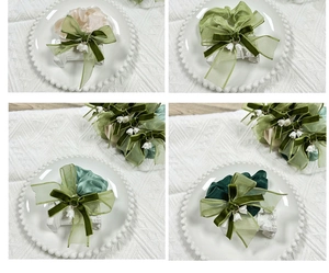 Detailed close-up of lily of the valley hair scrunchies with elegant green velvet bows