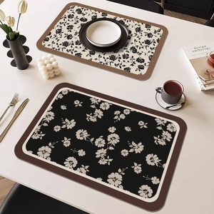 French waterproof leather placemats set with elegant floral patterns on a white table