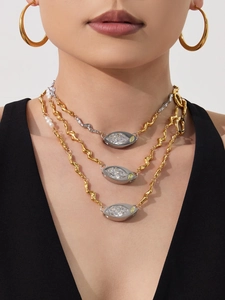 Detail view of multi-layered stainless steel necklace with marquise zircon and fresh pearls