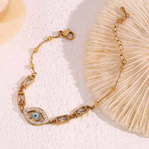 Close-up of 18K gold plated evil eye bracelet with blue enamel and crystal rectangle zircon