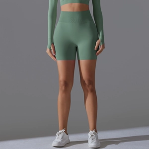 Detail of sage green seamless yoga set featuring thumb hole cuffs and ribbed waistband