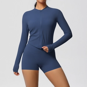 Detail of navy yoga set featuring thumbhole sleeves and high-waist compression shorts