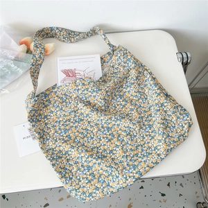 Detailed macro view of yellow floral canvas tote bag with rustic bohemian aesthetic