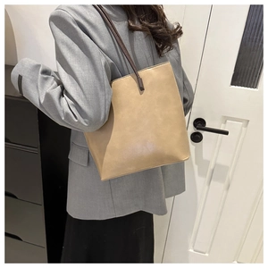 Minimalist khaki PU leather tote bag shown on model for daily commuting style