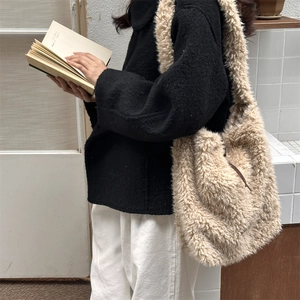 Detail view of plush beige faux fur tote bag with brown drawstring and plaid lining