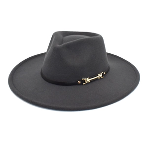 Macro detail of charcoal wool fedora with decorative black band and gold buckle